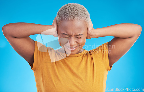 Image of Stress, headache or black woman cover ears in studio on blue background with noise crisis or anxiety. Conflict, scared person or African girl with fear of trauma, head pain or sound distraction