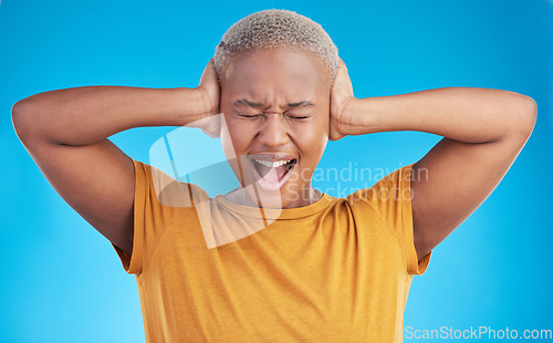 Image of Headache, hands on ears and black woman shout in studio isolated on a blue background. Stress, noise and African person frustrated with loud sound, pain or crisis of tinnitus, not hearing or listen