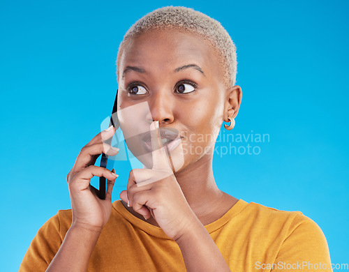 Image of Phone call, secret or finger on lips of black woman in studio for mystery, gossip or conversation. Privacy, news or whisper with girl or shush gesture on blue background for rumor, drama or silence