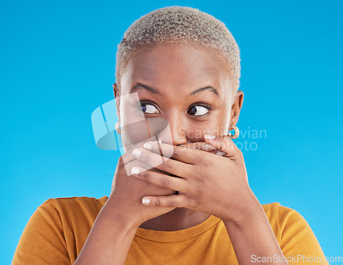 Image of Gossip, wow or black woman shocked by secret, mistake or announcement in studio on blue background. Thinking, fake news or surprised girl with excited, wtf or omg expression with hands to cover mouth