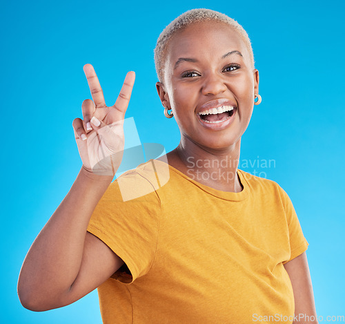 Image of Hand, peace and black woman portrait in studio with thank you, success or feedback on blue background. V, sign and African female face with good vibes, smile or freedom emoji or self love support