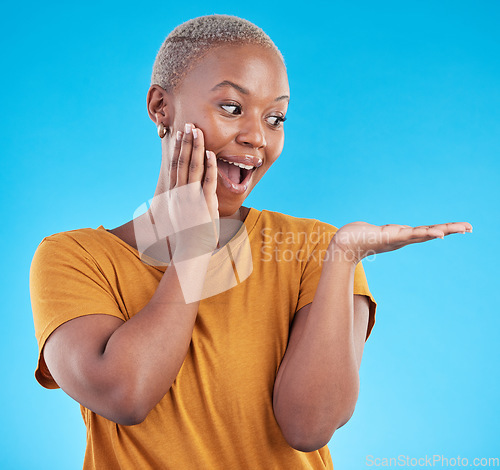 Image of Wow, mockup and promotion from a black woman on a blue background for marketing or a product. Sale, customer and an African girl or promoter with surprise and space for advertising or announcement