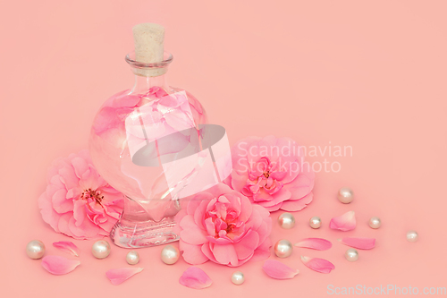 Image of Rose Flower Perfume with Pink Roses Pearls and Petals