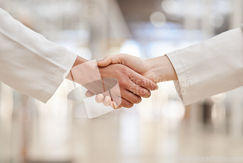 Image of Doctors, partnership and handshake for collaboration, agreement and teamwork. Shaking hands, medical professional and people in cooperation for healthcare, wellness and thank you, welcome and success