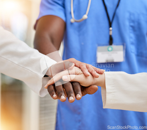 Image of Doctors, teamwork and hands together for support, collaboration and healthcare motivation, goals and faith. Hope, diversity and stack sign of medical people with clinic, hospital or surgery goals