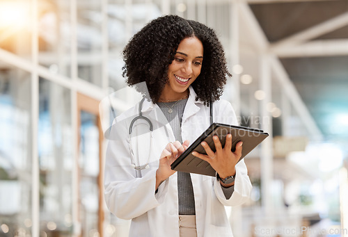 Image of Smile, doctor and woman with tablet for research, telehealth or healthcare in hospital. Technology, happy and African medical professional on wellness web app, online consultation and reading email