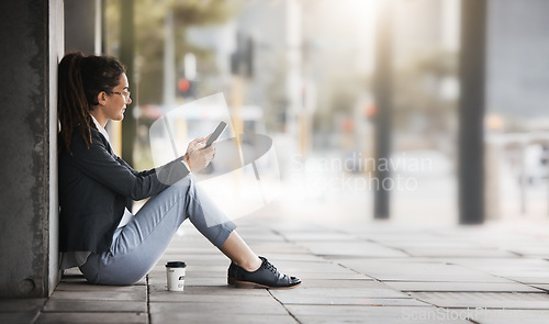 Image of Phone, woman and coffee break in the city, street or job search, employment or network on social media, internet or online. Unemployed, worker sitting and reading news or wanted ads on cellphone