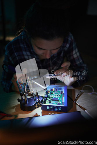 Image of Woman, computer motherboard and night with soldering iron, manufacturing and microchip for it development. Information technology, circuit board and electronics for engineering, hardware and system