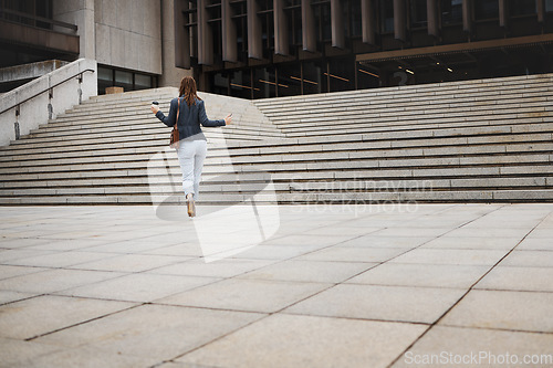 Image of Walking, travel and business woman in city with ambition for morning commute, journey and building. Professional, growth and back of female person by steps for career progress, work and job in town