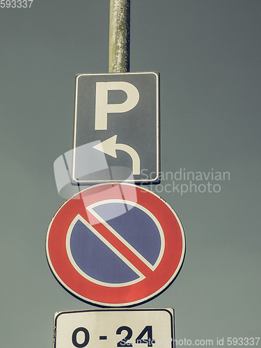 Image of Vintage looking No parking sign over blue sky