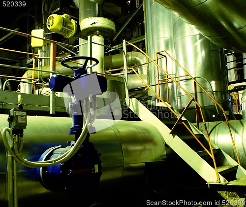 Image of Pipes, tubes, machinery and steam turbine at a power plant