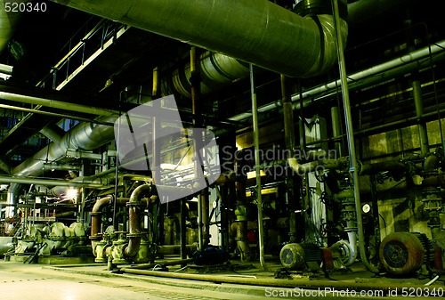 Image of Pipes, tubes, machinery and steam turbine at a power plant