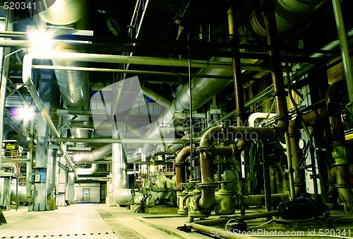 Image of Pipes, tubes, machinery and steam turbine at a power plant