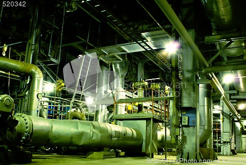 Image of Pipes, tubes, machinery and steam turbine at a power plant