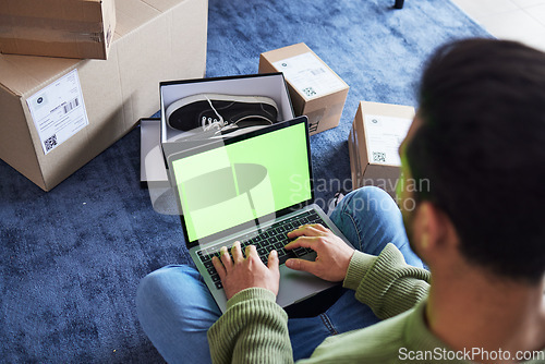 Image of Ecommerce, man with computer, green screen and box on carpet, shoes and delivery service on digital app. Sale, discount and online shopping on fashion retail brand website, internet search on laptop.