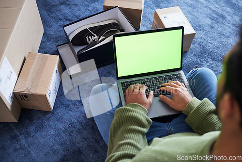 Image of Online shopping, man with laptop, green screen and package on floor, shoes and delivery service on digital app. Sale, discount and ecommerce on fashion retail website, internet search on computer.