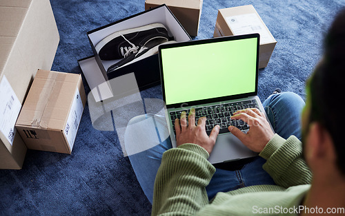 Image of Ecommerce, man with laptop, green screen and boxes on floor, shoes and delivery service on digital app. Sale, discount and online shopping on fashion retail brand website, internet search on computer