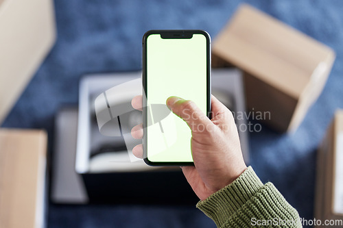 Image of Phone green screen, boxes and person hands online shopping, scroll ecommerce site or check omnichannel website. Courier service, mail shipping or home customer with cellphone, delivery app or package