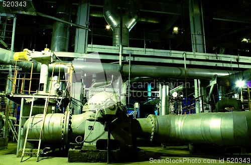 Image of Pipes, tubes, machinery and steam turbine at a power plant