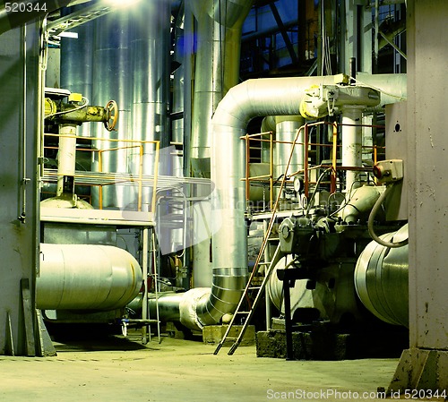 Image of Pipes, tubes, machinery and steam turbine at a power plant