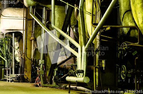 Image of Pipes, tubes, machinery and steam turbine at a power plant