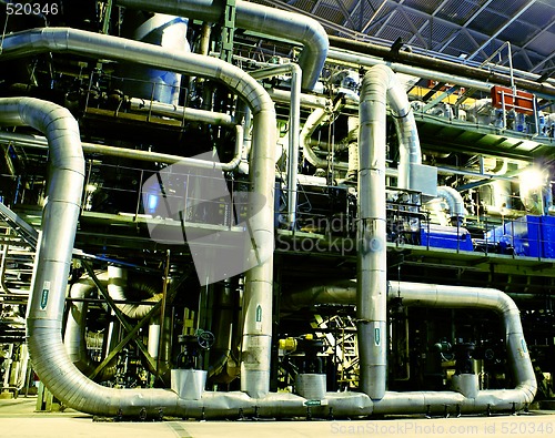 Image of Pipes, tubes, machinery and steam turbine at a power plant