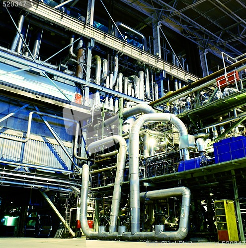 Image of Pipes, tubes, machinery and steam turbine at a power plant