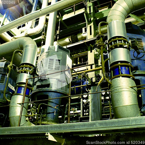 Image of Pipes, tubes, machinery and steam turbine at a power plant