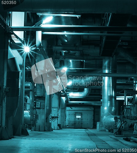 Image of Pipes, tubes, machinery and steam turbine at a power plant