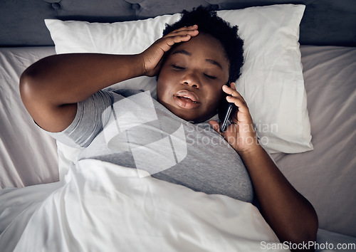 Image of Insomnia, night and black woman in bed on a phone call talking or speaking of death or problems at home. Stress, upset or sad person in conversation or discussion with mobile communication in bedroom