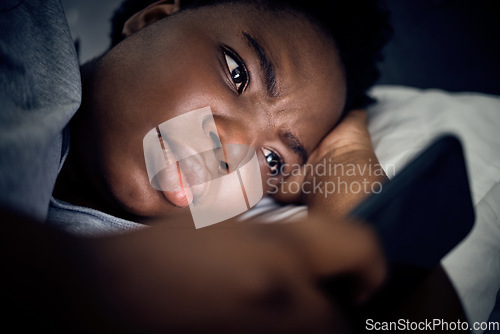 Image of Insomnia, night and black woman in bed with phone for social media lying in room for addiction at home. Stress, lonely or sad person reading online to scroll on mobile app in bedroom with depression