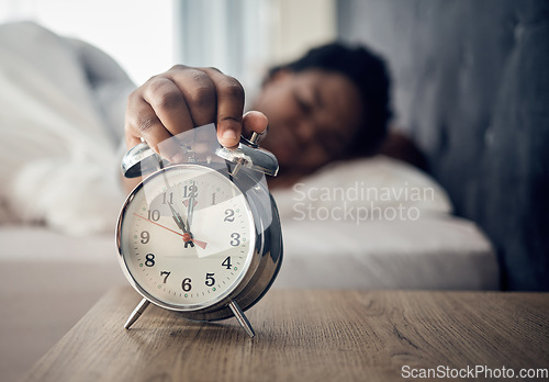 Image of Wake up, alarm clock or woman sleeping in bed in the morning after resting pressing a snooze button. Sleepy blur, hand or tired person at home getting up from nap in bedroom ready to start a new day