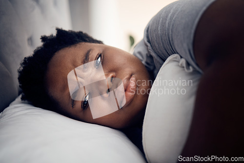 Image of Black woman, depression and insomnia with mental health problem, tired and stress with anxiety at home. Female person in bed, depressed and psychology with life crisis, sad with fatigue and grief