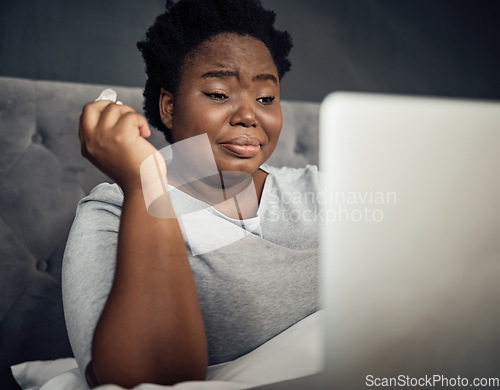 Image of Sad, crying and a black woman with a laptop in bed for a movie, film or show in a house. Depression, technology and an African person with a computer for an online drama or social media notification