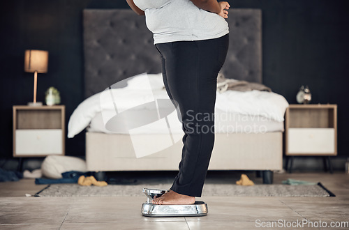 Image of Legs, scale and weightloss with a person the bedroom of their home for health, fitness or body wellness. Diet, measure and progress with a plus size adult weighing to track the results of a workout