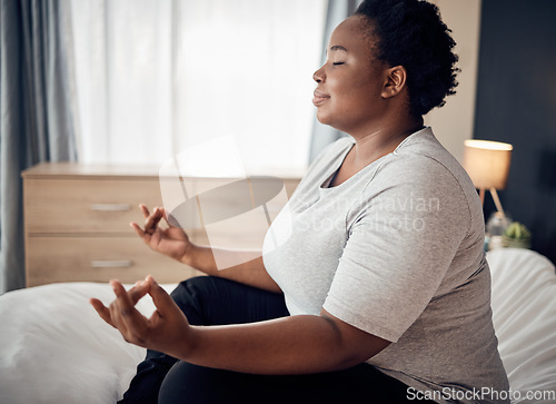 Image of Yoga, lotus and meditation of black woman on bed for peace, mindfulness or exercise. Pilates, workout and person in bedroom for zen, relax and health of plus size body, wellness and fitness at home