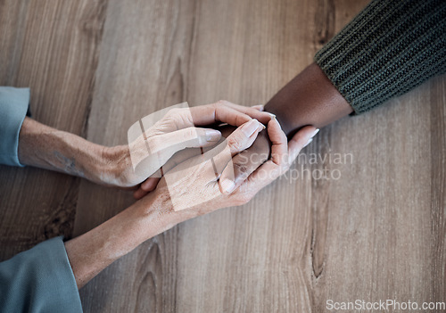 Image of Holding hands, support and counselling, help and trust with people, top view with psychology and people pray together. Kindness, respect and worship, therapy and wellness with communication and care