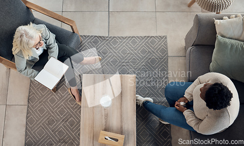 Image of People, therapy patient and notebook for counseling, psychology evaluation and mental health support or helping. Life coach, therapist or doctor listening to client and women consulting from above