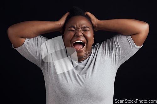 Image of Anger, frustrated and black woman screaming, depression and mental health on a dark black studio background. Person, emotion and model shouting, anxiety and angry with grief, moody and lose control