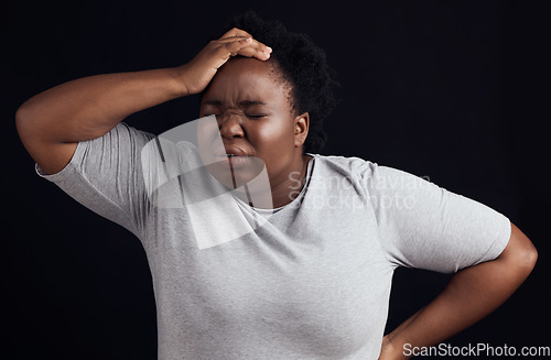 Image of Frustrated black woman, headache and anxiety in studio of stress, trauma or problem on dark background. Face of confused model in burnout, brain fog or crazy fear of pain, depression or mental health