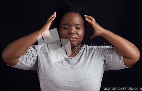 Image of Frustrated black woman, stress and anxiety in studio with fear of crazy memory, trauma or noise in mind on dark background. Face of confused model in burnout, brain fog or depression of mental health