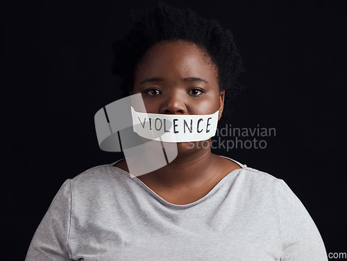 Image of Portrait, censorship and a black woman in protest of domestic violence on a dark background. Freedom, gender equality or empowerment with a serious young female person in studio for human rights