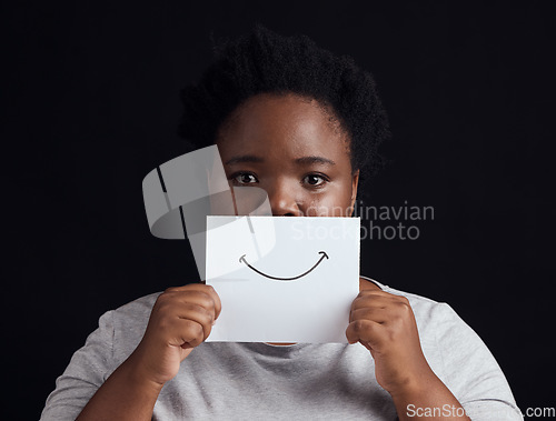 Image of Paper smile, portrait and a black woman on a studio background for mental health, problem or fear. Advertising psychology, poster and the face of an African patient or girl with bipolar or sad