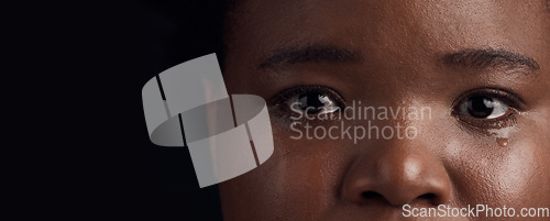 Image of Black woman, eyes and mental health, crying with depression and crisis with abuse on dark background. Sad, portrait and anxiety, depressed female person with face on banner and grief in studio