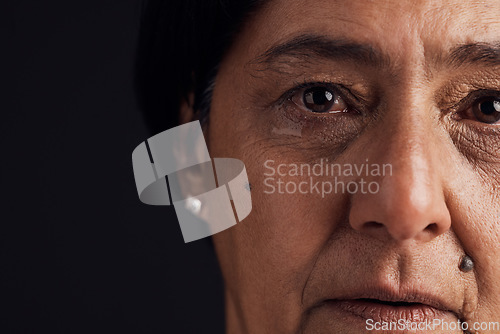 Image of Old woman, face and mental health, crying with depression and crisis, abuse isolated on black background. Sad, loss and anxiety with depressed female person, problem in life and grief in a studio