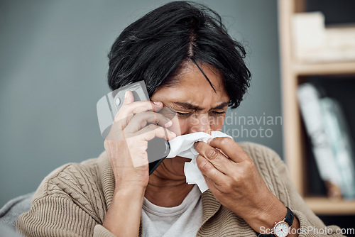 Image of Phone call, sick and woman blowing her nose for the flu, cold or sinus allergies at her home. Illness, telehealth and senior female person with tissue on a medical doctor consultation with cellphone.