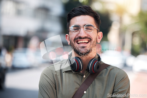 Image of Travel, city and portrait of a man outdoor on a road with a smile, glasses and headphones. Happy student or business person on urban street with freedom and pride for creative internship in Miami