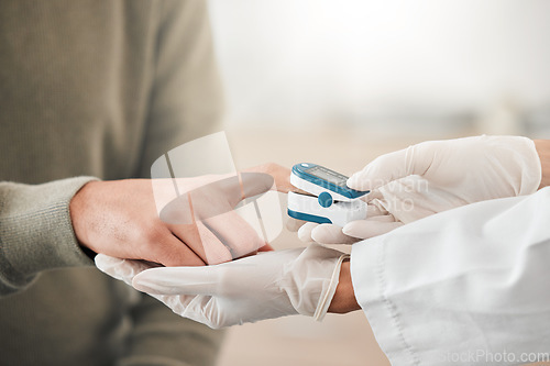 Image of Blood pressure, doctor and hands test patient with hypertension and technology help person with healthcare check. Digital, device and man finger at a medical exam for diabetes support with equipment