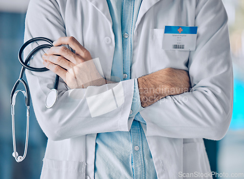 Image of Man, doctor and hands in professional healthcare with arms crossed or stethoscope at the hospital. Closeup of male person, nurse or surgeon in confidence for medical procedure or surgery at clinic