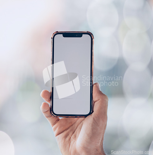 Image of Person, hands and phone mockup screen for advertising, social media app or networking space on a bokeh background. Closeup of mobile smartphone display for advertisement, logo branding or marketing